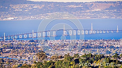 Aerial view of San Mateo Bridge, connecting the Peninsula and East Bay; residential areas of Foster City visible in the foreground Stock Photo