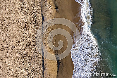 Aerial view of sea waves and a remote secluded sandy beach Stock Photo