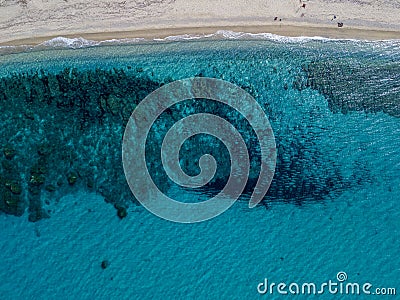 Aerial view of a seabed with rocks emerging from the sea, seabed seen from above, transparent water and beach Stock Photo