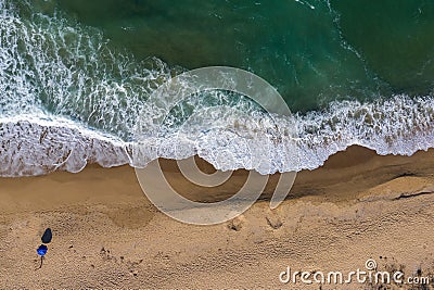 Aerial view of secluded beach with a beach umbrella Stock Photo