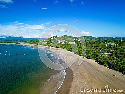 Aerial view of a secluded sandy beach surrounded by clear blue ocean waters. Stock Photo