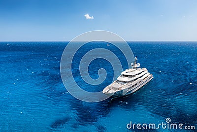 Aerial view of the ship from drone. Blue clear water in the Mediterranean Sea. Summer vacation and travel on a cruise liner. Stock Photo