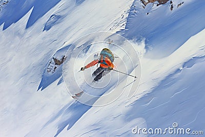 aerial view of a skier going downhill on a pristine, untouched powdery slope Stock Photo