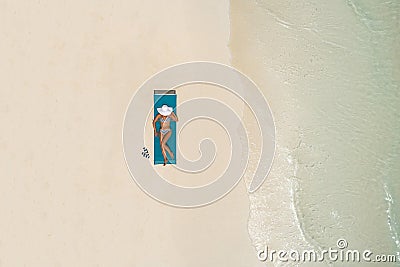 Aerial view of slim woman sunbathing lying on a beach chair in Maldives. Summer seascape with girl, beautiful waves, colorful Stock Photo