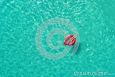 Aerial view of slim woman swimming on the swim ring in the trans Stock Photo