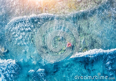 Aerial view of slim young woman swimming on the donut swim ring Stock Photo