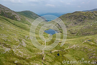 Aerial view of a small lake in a rugged mountain pass Stock Photo