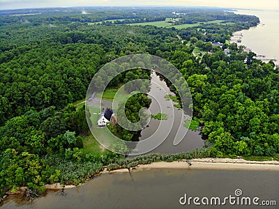 The aerial view of a small river, green trees and a white beach near Rock Point, Maryland, U.S Stock Photo