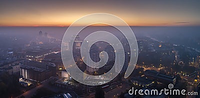 Aerial view of the smog over the waking city at dawn, buildings covered with fog and smog Stock Photo