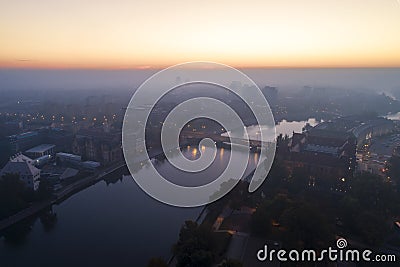 Aerial view of the smog over the waking city at dawn, in the distance buildings covered with fog and smog Stock Photo