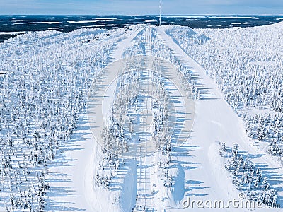 Aerial view of snow covered forest and ski resort slope in winter Finland Lapland Stock Photo