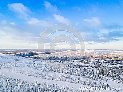 Aerial view of snow covered winter forest and road. Beautiful rural landscape in Finland Stock Photo