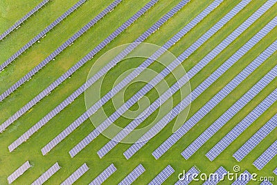 Aerial view of solar power plant on green field. Electric panels for producing clean ecologic energy. Solar cell field. megawatt Stock Photo