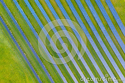 Aerial view of solar power plant on green field. Electric panels for producing clean ecologic energy. Solar cell field. megawatt Stock Photo