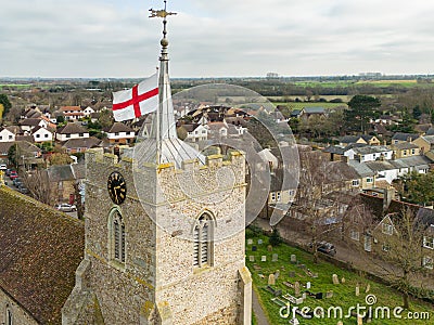 Aerial view of a St Georges English nation flag seen atop on English village church tower. Stock Photo