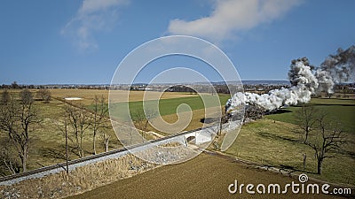 Aerial View of a Steam Double-Header Freight , Passenger Train Approaching Blowing Lots of Smoke Stock Photo