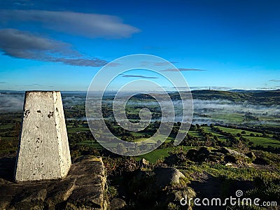 Aerial view of stone in background of greenery field with dense trees in Pendle hill Stock Photo