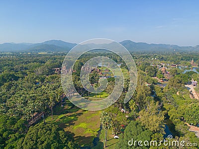 Aerial view of Sukhothai Historical Park, buddha pagoda stupa in a temple, Sukhothai, Thailand with green mountain hills and Stock Photo