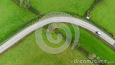 Aerial view taken from above of a sharp bend in a road with Chevron warning signs. Stock Photo