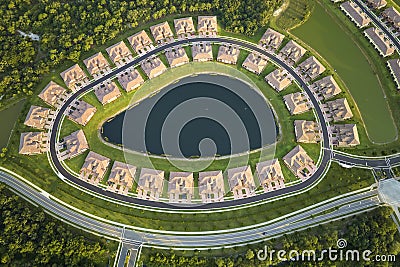 Aerial view of tightly packed homes in Florida closed living clubs with lake water in the middle. Family houses as Stock Photo