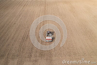 Aerial view of tractor doing farming and sowing wheat Stock Photo