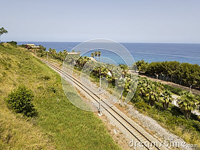 Aerial view of train tracks crossing the coast with sea Stock Photo