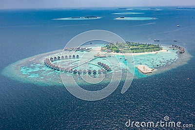 Aerial view of a tropical island in turquoise water. Luxurious over-water villas on tropical island resort maldives Stock Photo