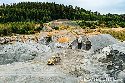 Aerial view of Truck excavator in open sand quarry rubble in Finland Stock Photo