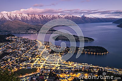 Aerial night view of twilight Queenstown and snow covered Remarkables, New Zealand Stock Photo