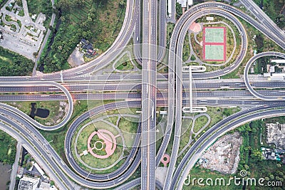 Aerial view of urbal highway intersection road with green exercise background Stock Photo