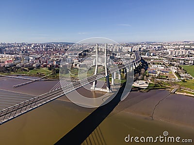Aerial view of Vasco da Gama bridge crossing the Tagus river with Lisbon skyline Editorial Stock Photo
