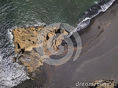 Aerial view of waves crashing on a rock formation. Playa El Golfo. Black beach of the Charco de los Clicos. Lanzarote, Spain Stock Photo