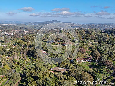 Aerial view of wealthy countryside area with luxury villas with swimming pool, surrounded by forest and mountain valley Stock Photo