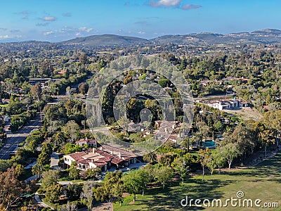 Aerial view of wealthy countryside area with luxury villas with swimming pool, surrounded by forest and mountain valley Stock Photo