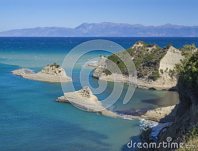 Aerial view on of white rock steep cliff volcanic bay of Cape Drastis and Peroulades area with tropical deep turquoise Stock Photo