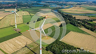 Aerial view of wind turbines windmills in farming fields. Alternative ecological energy production in Germany Stock Photo