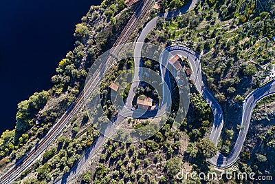 Aerial view of a winding road and train tracks along the Tagus River near the village of Belver in Portugal Stock Photo