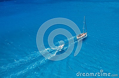 An aerial view of the yacht on the azure sea. Transparent clear water in the Mediterranean Sea. Summer vacations and travels on a Stock Photo