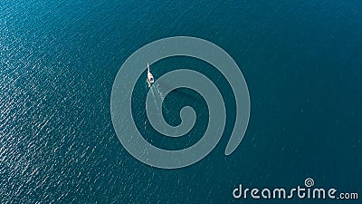 Aerial view on a yacht racing along tiny island ocean on sunny day. Coromandel Peninsula, New Zealand Stock Photo