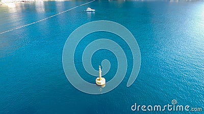 Aerial view of Yellow Sea Buoy in turquoise water of Mediterranean Sea. Marine Navigation Buoy. Safe water mark. Editorial Stock Photo