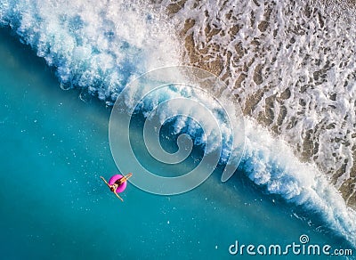 Aerial view of young woman swimming on the pink swim ring Stock Photo