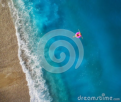 Aerial view of young woman swimming on the pink swim ring Stock Photo