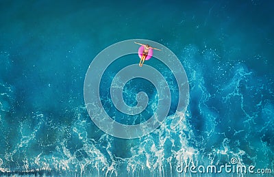 Aerial view of young woman swimming on the pink swim ring Stock Photo