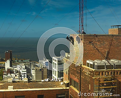 Aerial workers on tall building Editorial Stock Photo