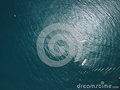 Aerial yacht on calm sea. Luxury cruise trip. View from above of white boat on deep blue water. Aerial view of rich Stock Photo