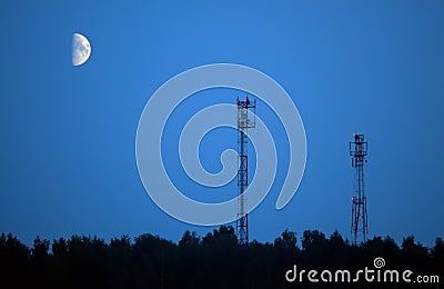 Aerials of cellular communication and moon Stock Photo