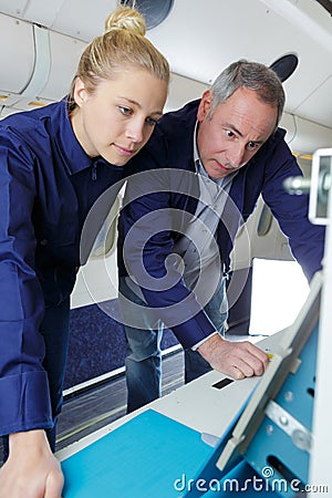 Aero engineer and apprentice working on aircraft Stock Photo