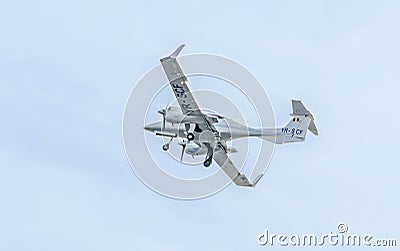 Aerobatic airplane pilots training in the sky of the city. Diamond airplane. Aeroshow Editorial Stock Photo