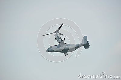 Aerobatic flying display by US Air Force (USAF) MV-22 Osprey tilt-rotor aircraft at Singapore Airshow Editorial Stock Photo