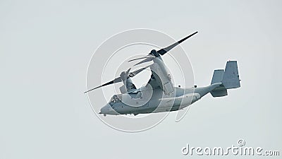 Aerobatic flying display by US Air Force (USAF) MV-22 Osprey tilt-rotor aircraft at Singapore Airshow Editorial Stock Photo